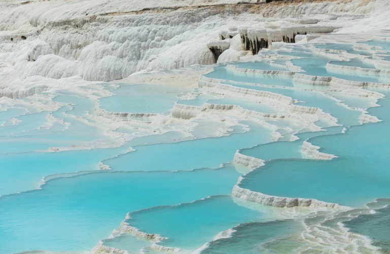 Pamukkale: White travertine terraces, thermal springs.