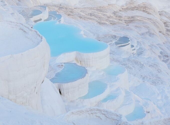 Pamukkale’s travertine terraces create a striking white landscape of beauty