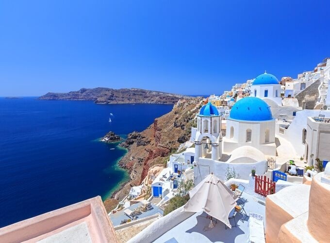 Santorini’s caldera sparkling under clear sky and endless sun