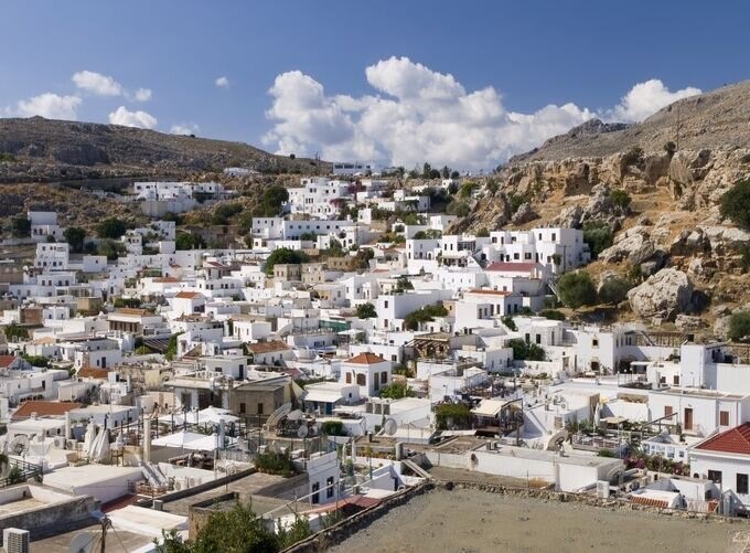  Charming Rhodes alley with blooming flowers and traditional stone buildings