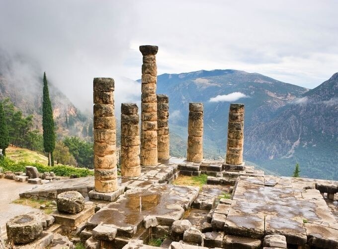 Temple of Apollo at Delphi glowing under Mediterranean golden sunlight