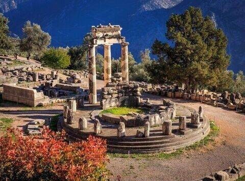 A quiet pathway through Delphi ruins with stunning mountain views