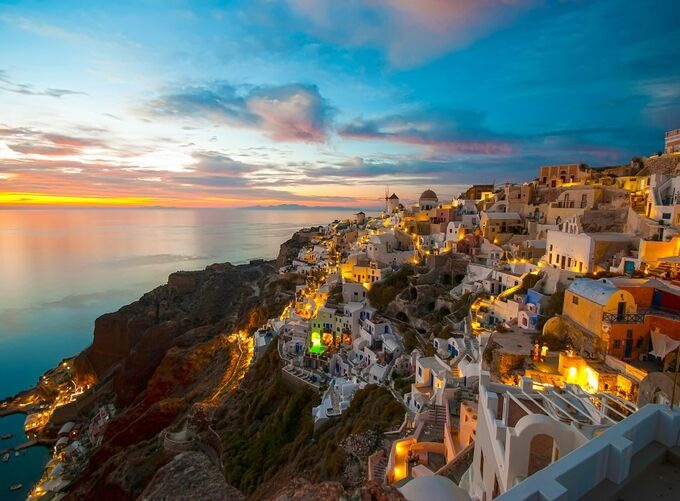 White balconies overlooking Santorini’s azure sea and caldera views