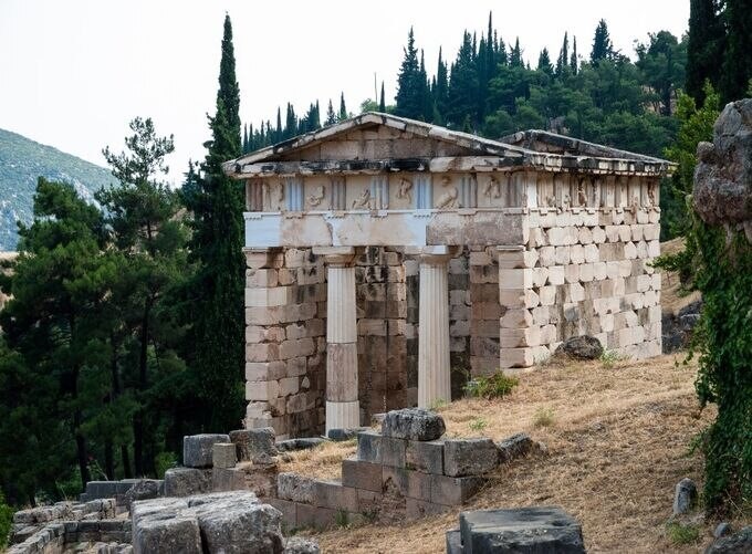 Sacred ruins of Delphi surrounded by vibrant green Mediterranean hills