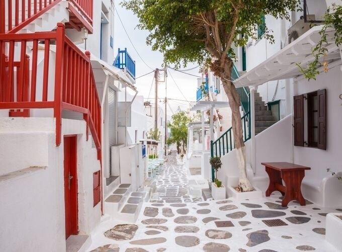 Mykonos’ whitewashed buildings glowing under the golden Mediterranean sunlight