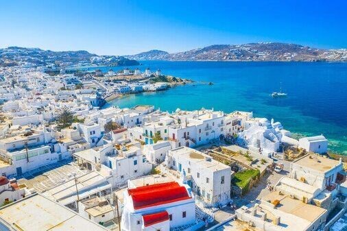 Bougainvillea flowers adding vibrancy to Mykonos’ whitewashed streets charmingly