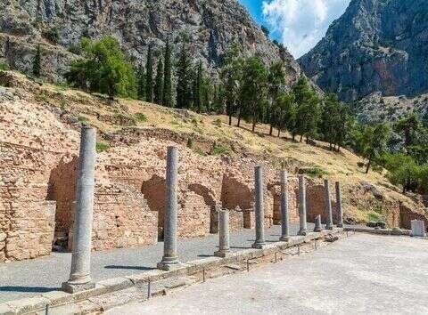 Ancient pathway leading through Delphi’s ruins under Mediterranean sunlight