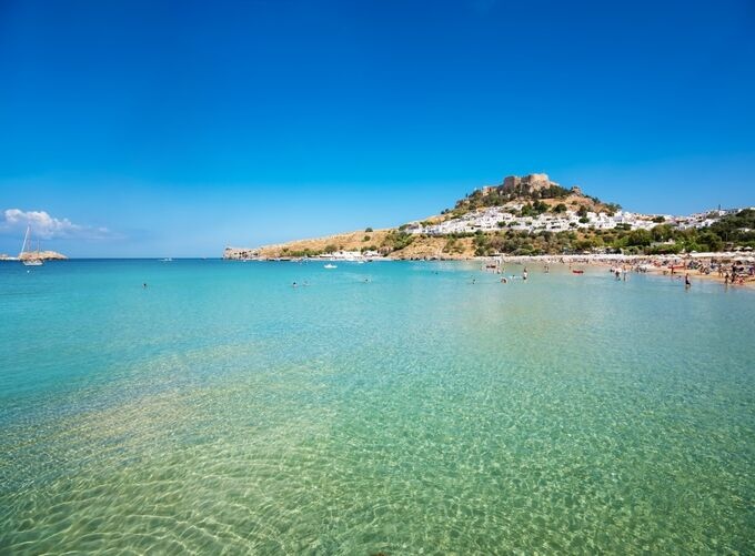 Historic windmills at Mandraki Harbor overlooking Rhodes' shimmering waters