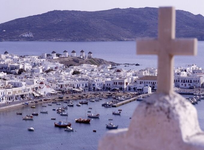 Golden sands of Mykonos beaches stretching along turquoise Aegean waters