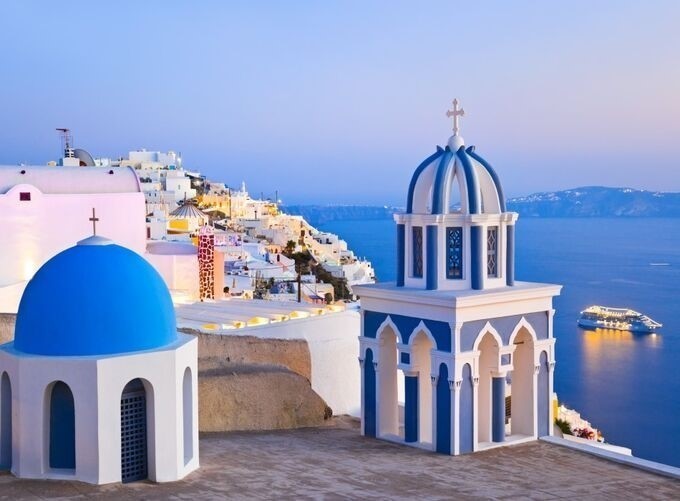 Santorini’s pristine architecture glowing under golden hour light stunningly