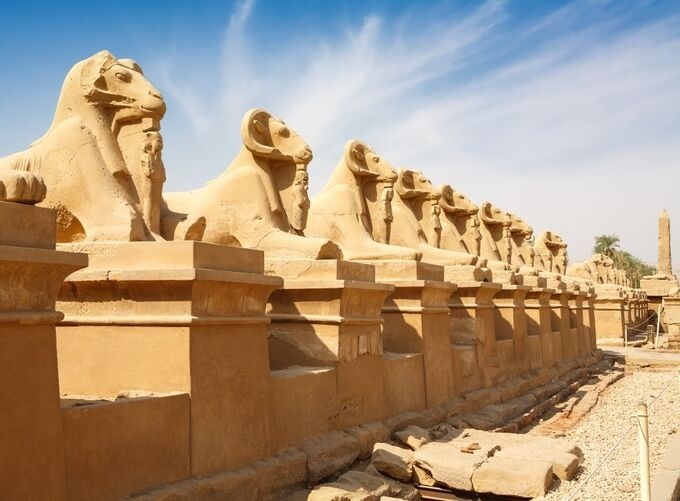 Golden sunlight glowing over Luxor Temple and surrounding palm groves