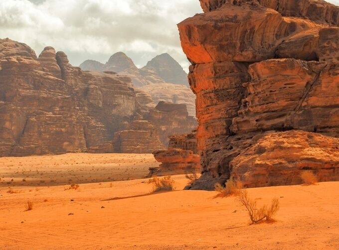 Camel caravan crossing Wadi Rum’s vast golden desert landscapes